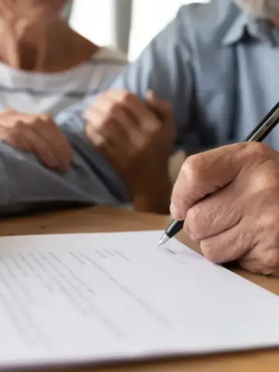 Several hands with pens