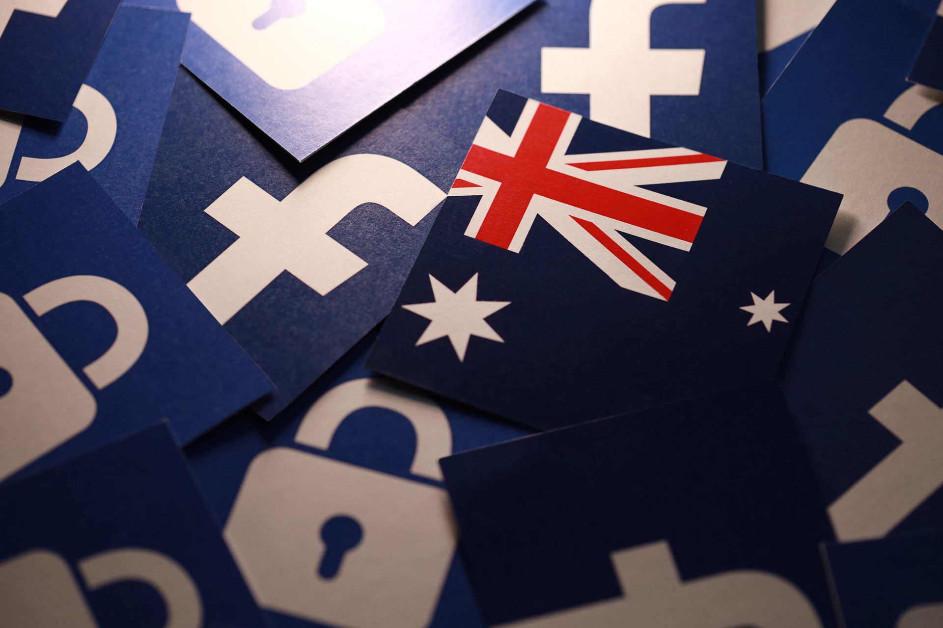 A pile of Australian flag stickers with a Facebook sticker on top.
