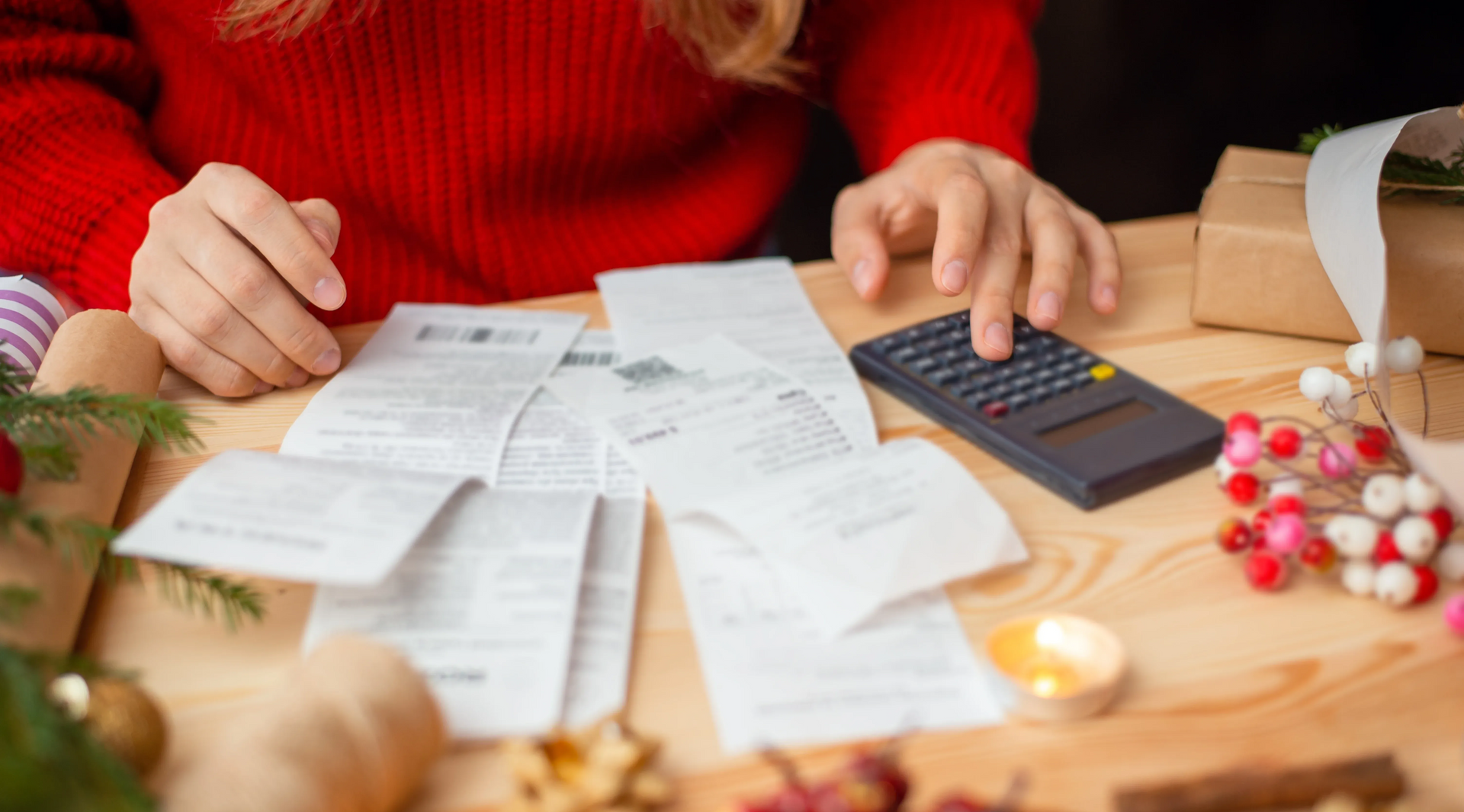 woman in red going through invoices during holidays