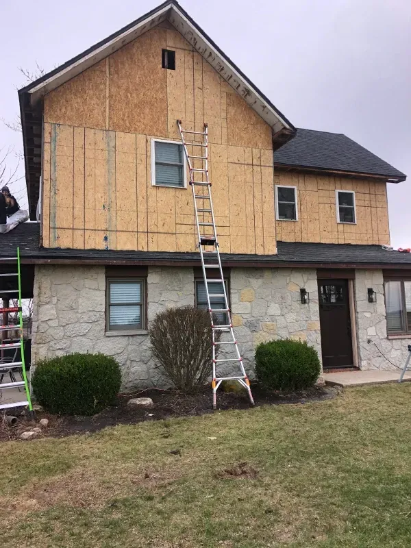 Unfinished basement with concrete floor, wooden framing, exposed pipes, and insulation.