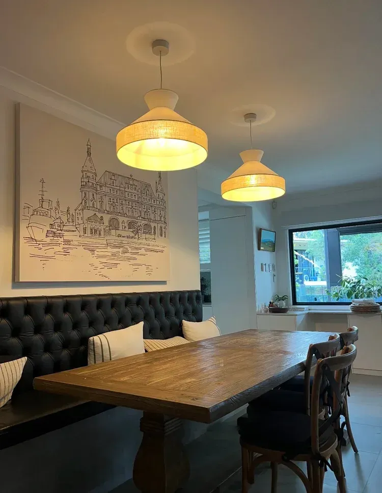 Dining Area With a Wooden Table, Tufted Dark Bench Seat — BTM Electrical & Air in Southport, QLD