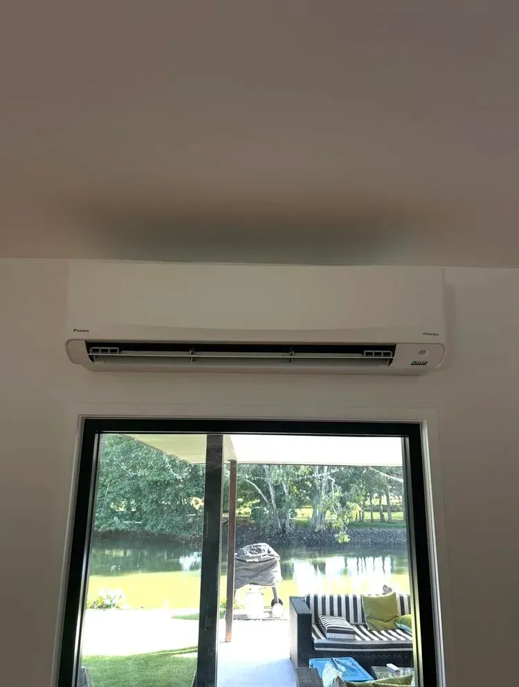 A White Wall-mounted Air Conditioner Unit Installed — BTM Electrical & Air in Southport, QLD