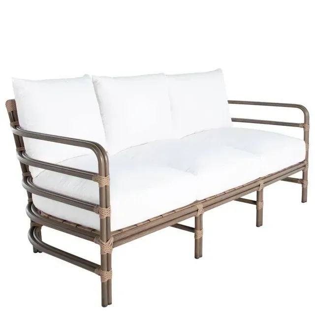 Outdoor sofa with brown metal frame, white cushions, and light brown woven accents.
