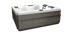 A rectangular hot tub with grey wooden siding and a white interior.