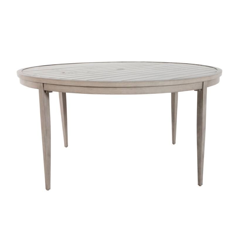 Round outdoor dining table with light wood finish, four legs, and patterned tabletop.