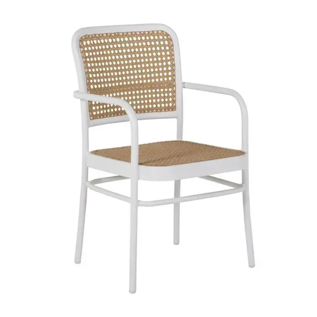 White chair with woven cane seat and back; outdoor setting.