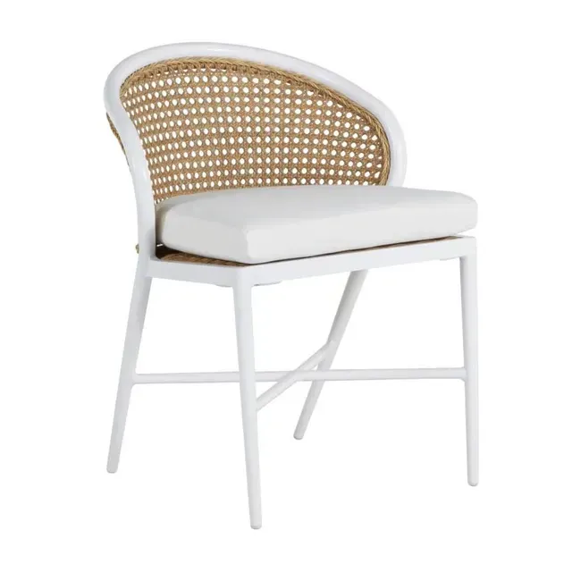 White chair with cane back and white cushion on a white frame.