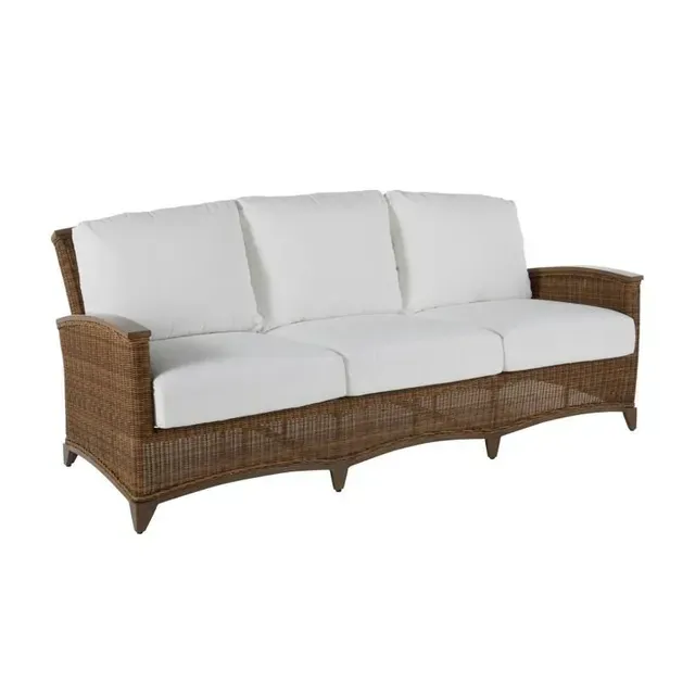 Brown wicker outdoor sofa with white cushions.