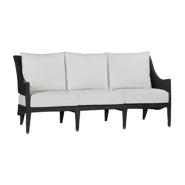 Black wicker outdoor sofa with white cushions.