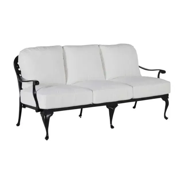 Black metal outdoor sofa with white cushions.