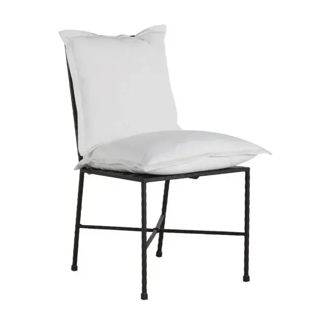 Black metal chair with a large white cushion on the seat and back.