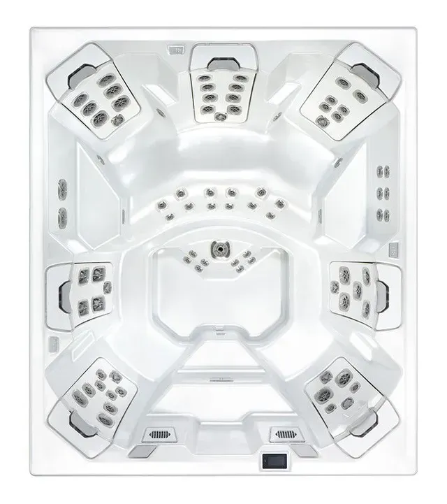 Top-down view of a white hot tub with multiple seating areas and jet controls.