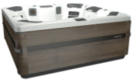 Brown and white hot tub with seating, surrounded by wood-like siding.