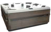 Modern hot tub with dark wood-grain exterior and gray and white interior, outdoors.