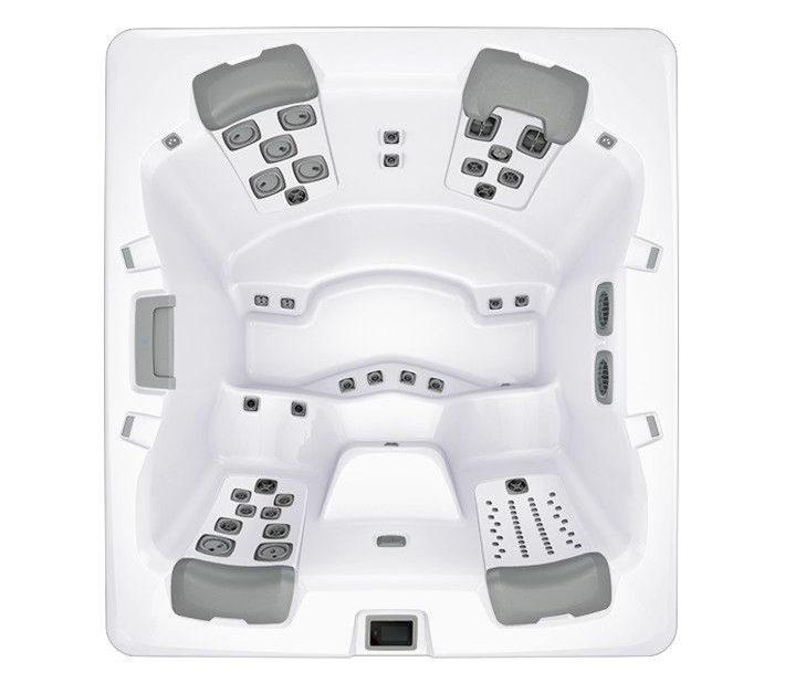 Overhead view of a square white hot tub with gray seating and control panels.