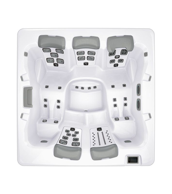 Overhead view of a white hot tub with gray headrests and numerous jet configurations.