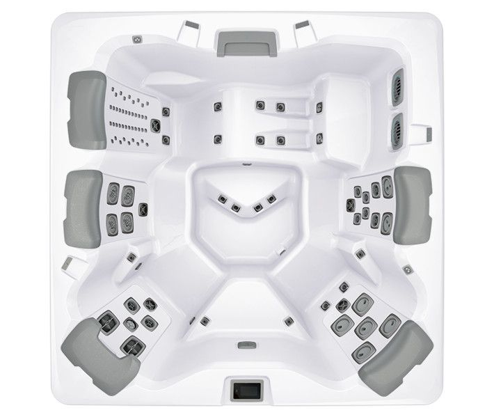Top-down view of a large white hot tub with multiple grey seats and jets.