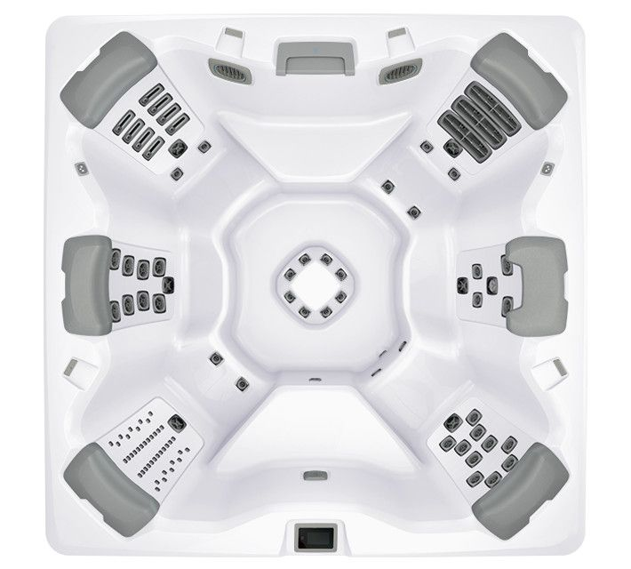 Top-down view of a white, multi-person hot tub with grey headrests and jets.
