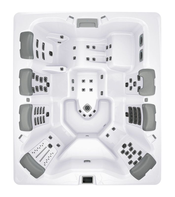 Overhead view of a white hot tub with grey headrests and jets.