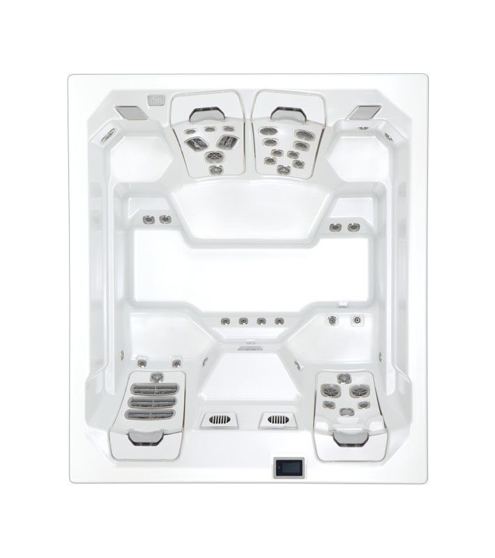 Top-down view of a white hot tub interior with multiple jet controls and seating areas.