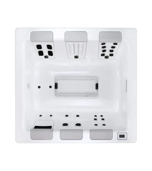 Top-down view of a white hot tub with gray headrests and multiple jet configurations.