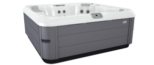 A gray and white hot tub. The exterior has horizontal gray panels.