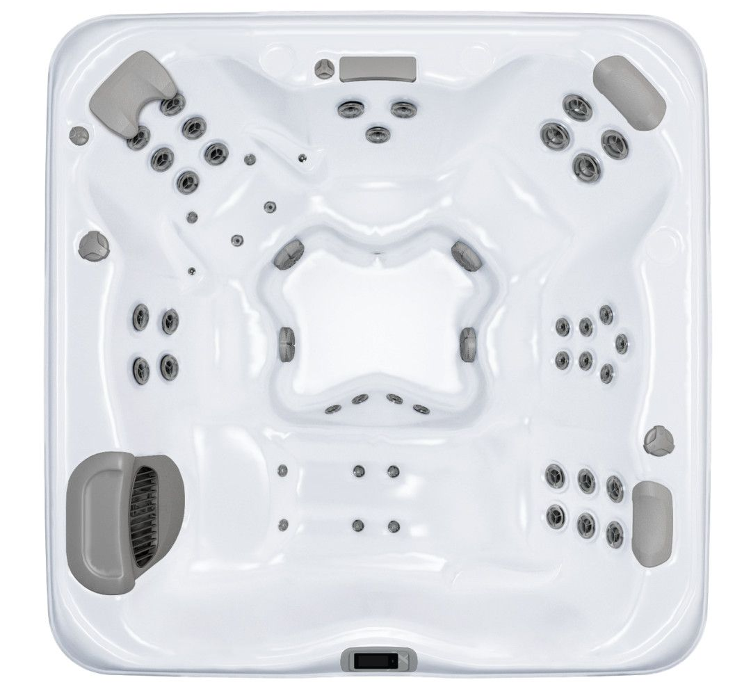 Overhead view of a white square hot tub with gray headrests and numerous jet nozzles.