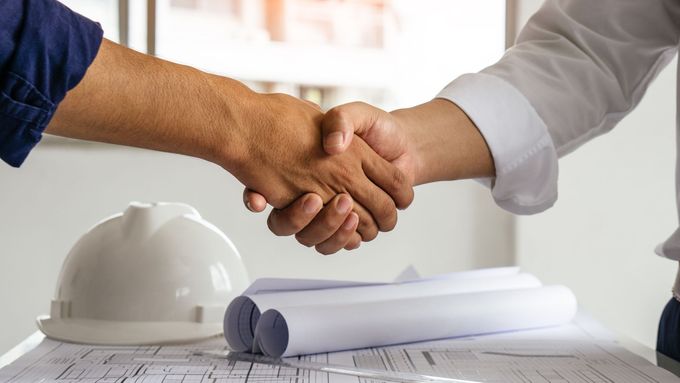 engineer and contractor shaking hands
