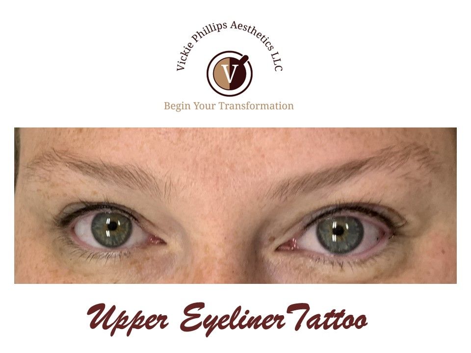 A close up of a woman 's eyes with the words upper eyeliner tattoo below them