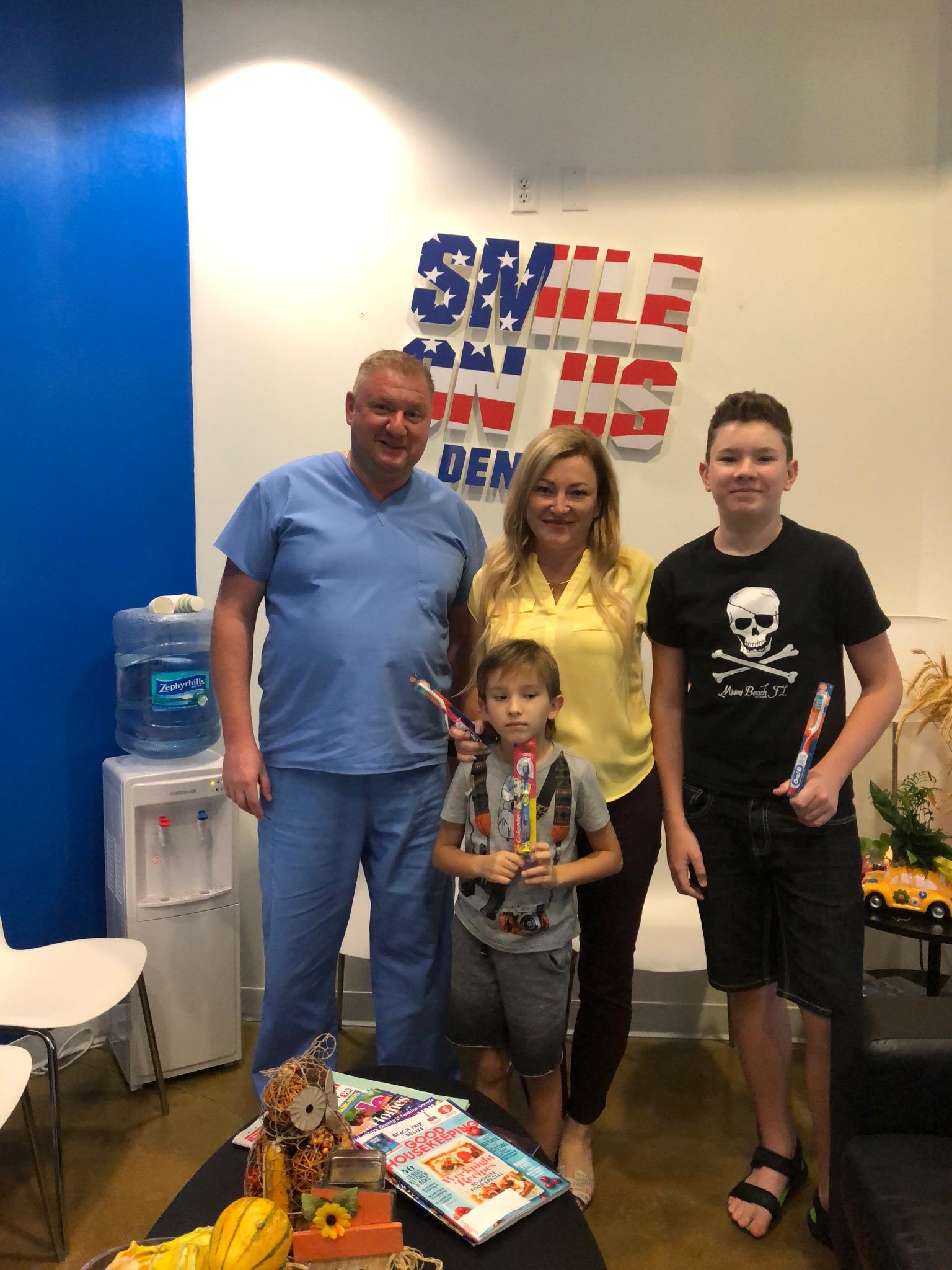 Dr. Illya Freyberg taking a picture witha family