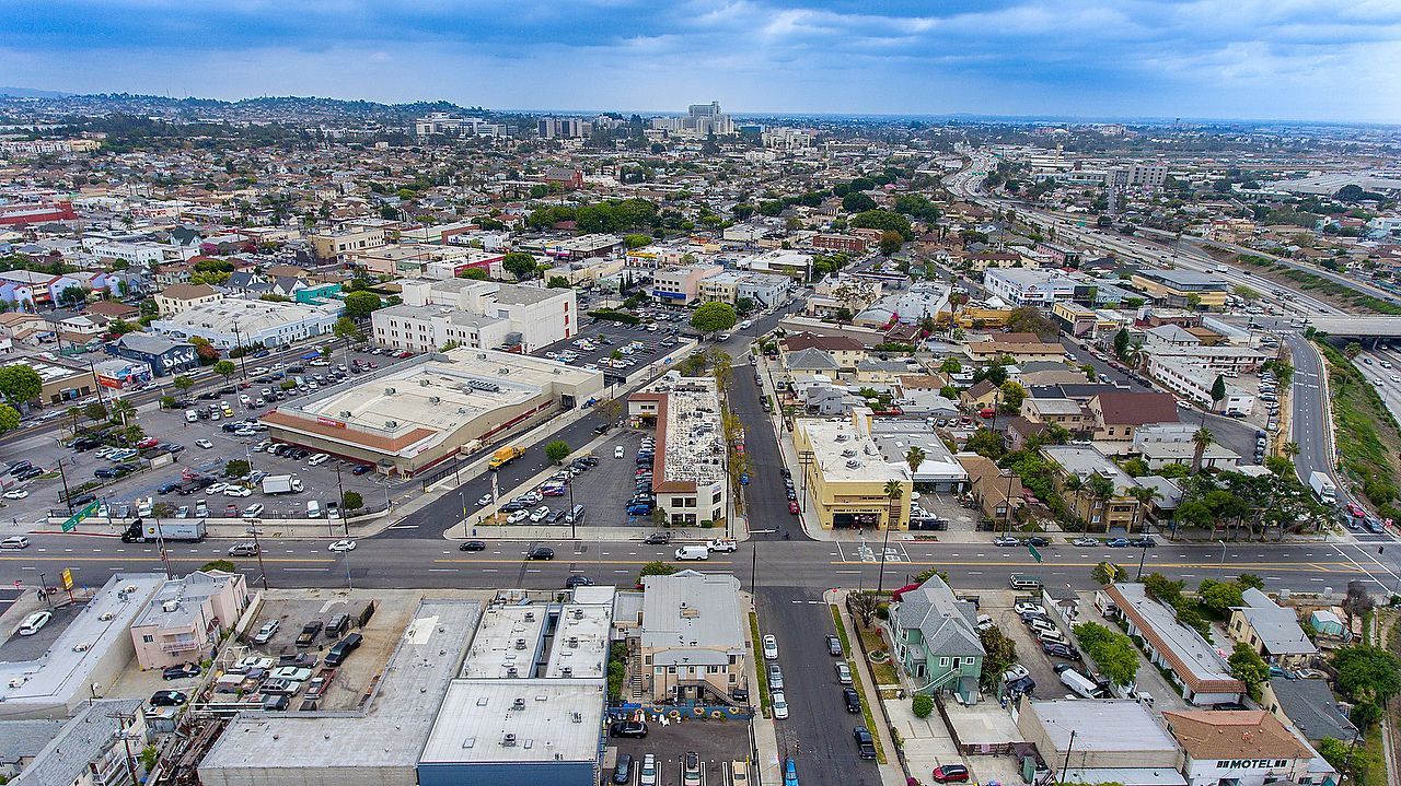 An aerial view of a city with lots of buildings and trees.