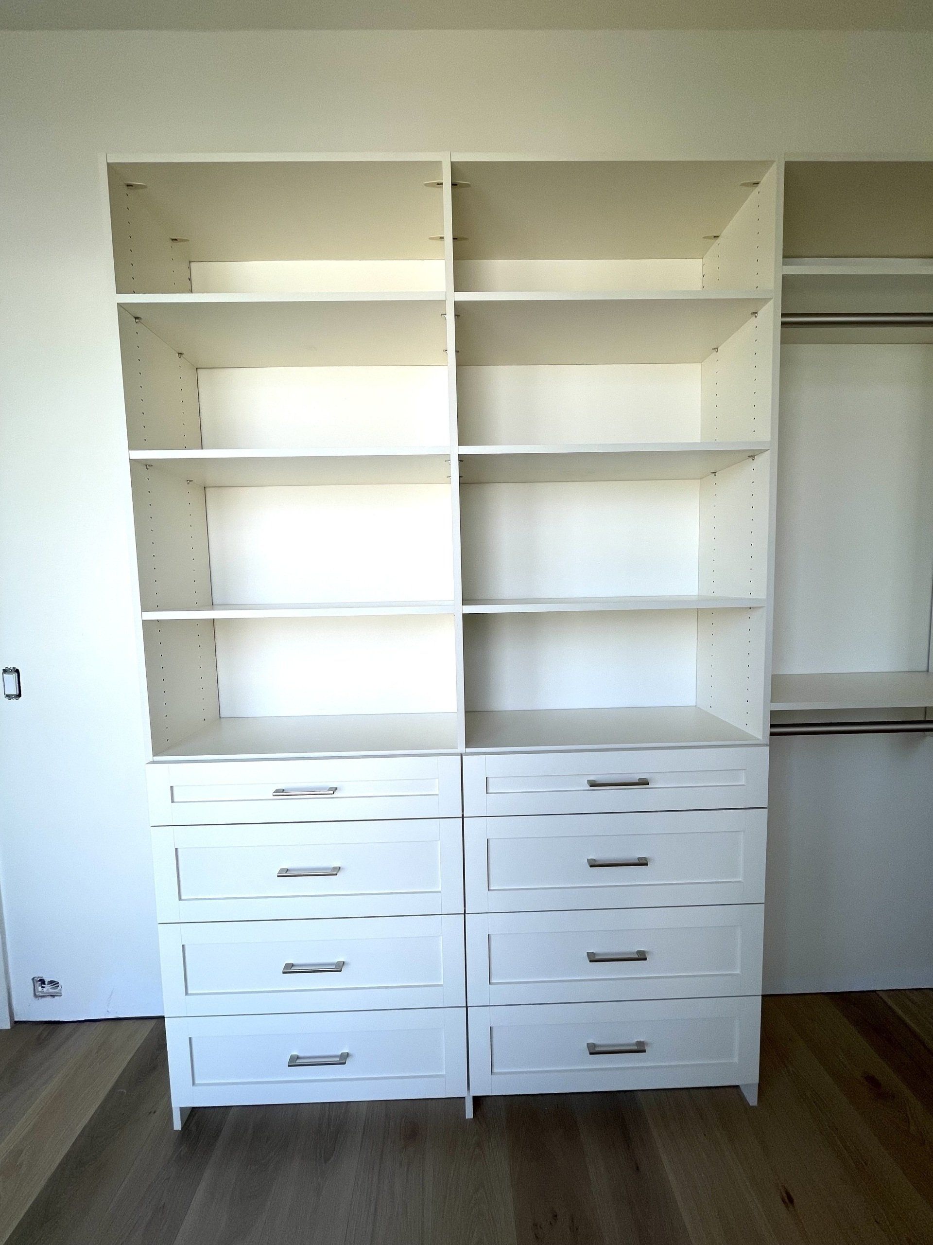 A closet with a lot of shelves and drawers
