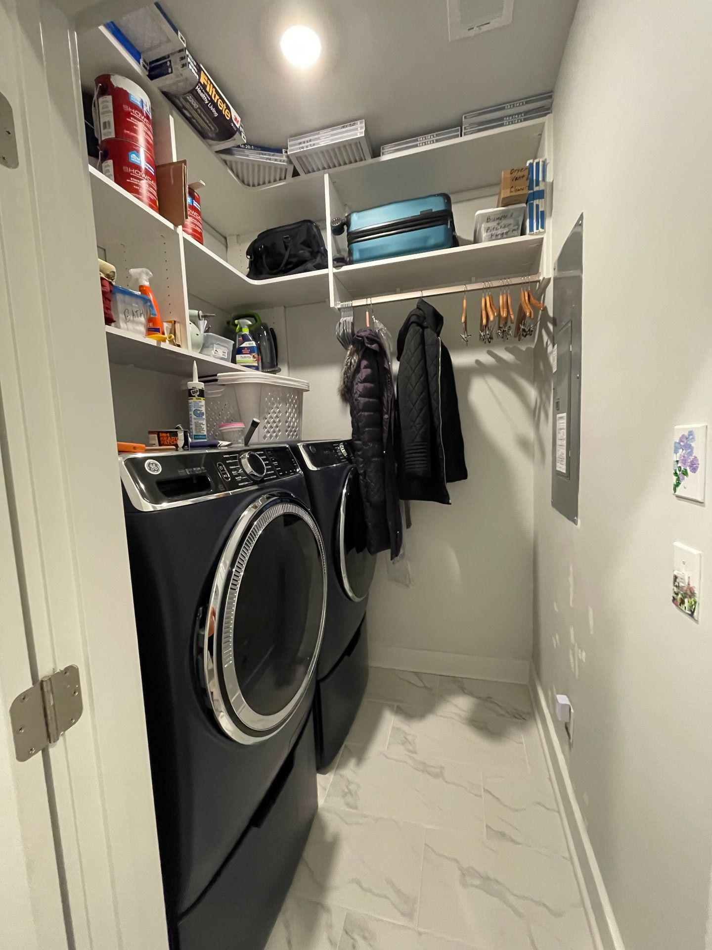 A laundry room with a washer and dryer in it.