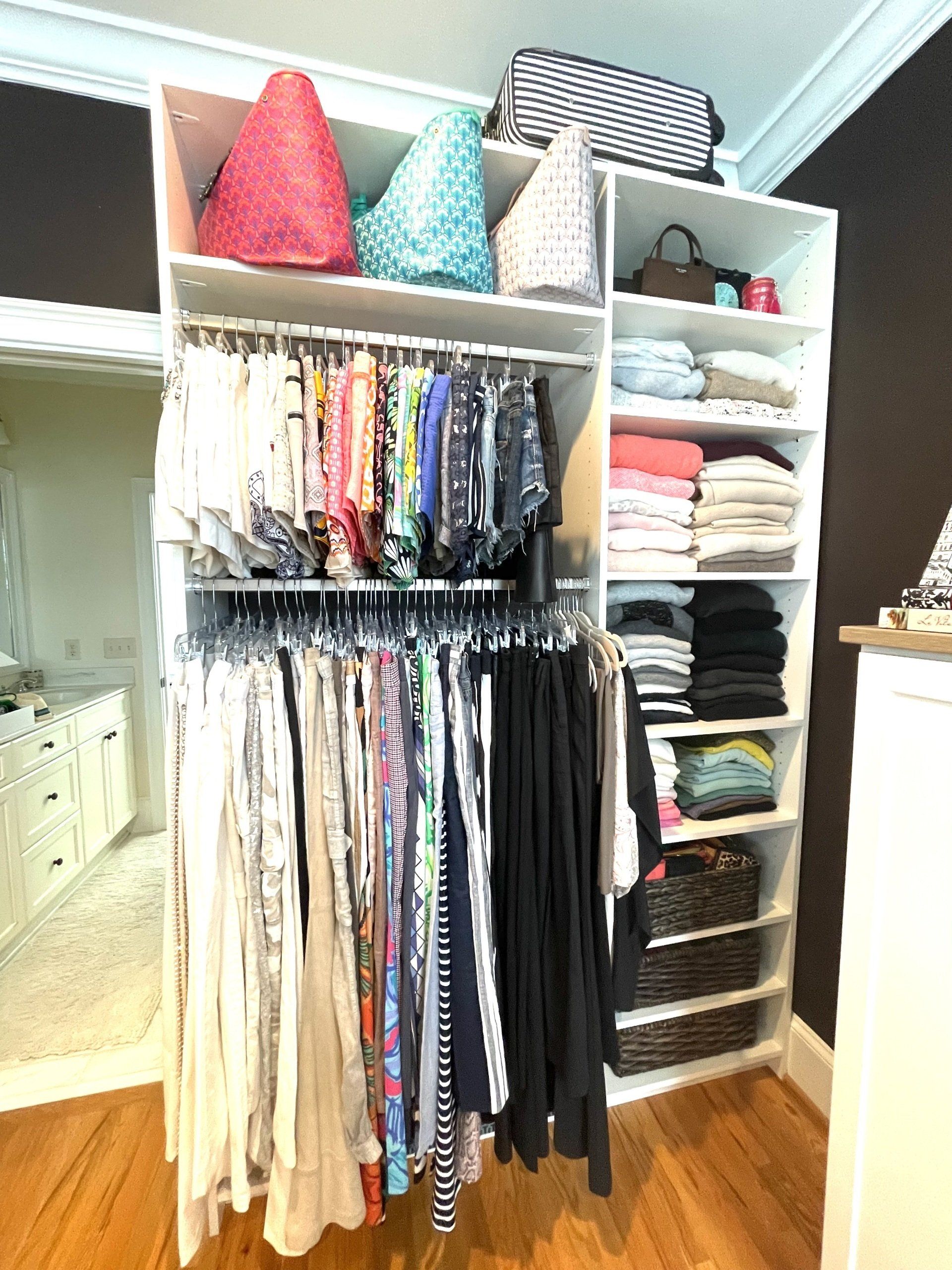 A closet filled with lots of clothes and bags