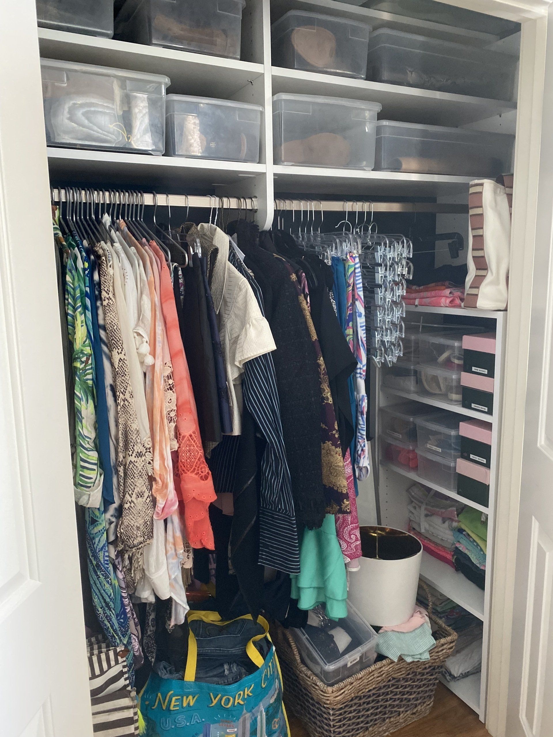 A closet filled with clothes and a bag that says new york