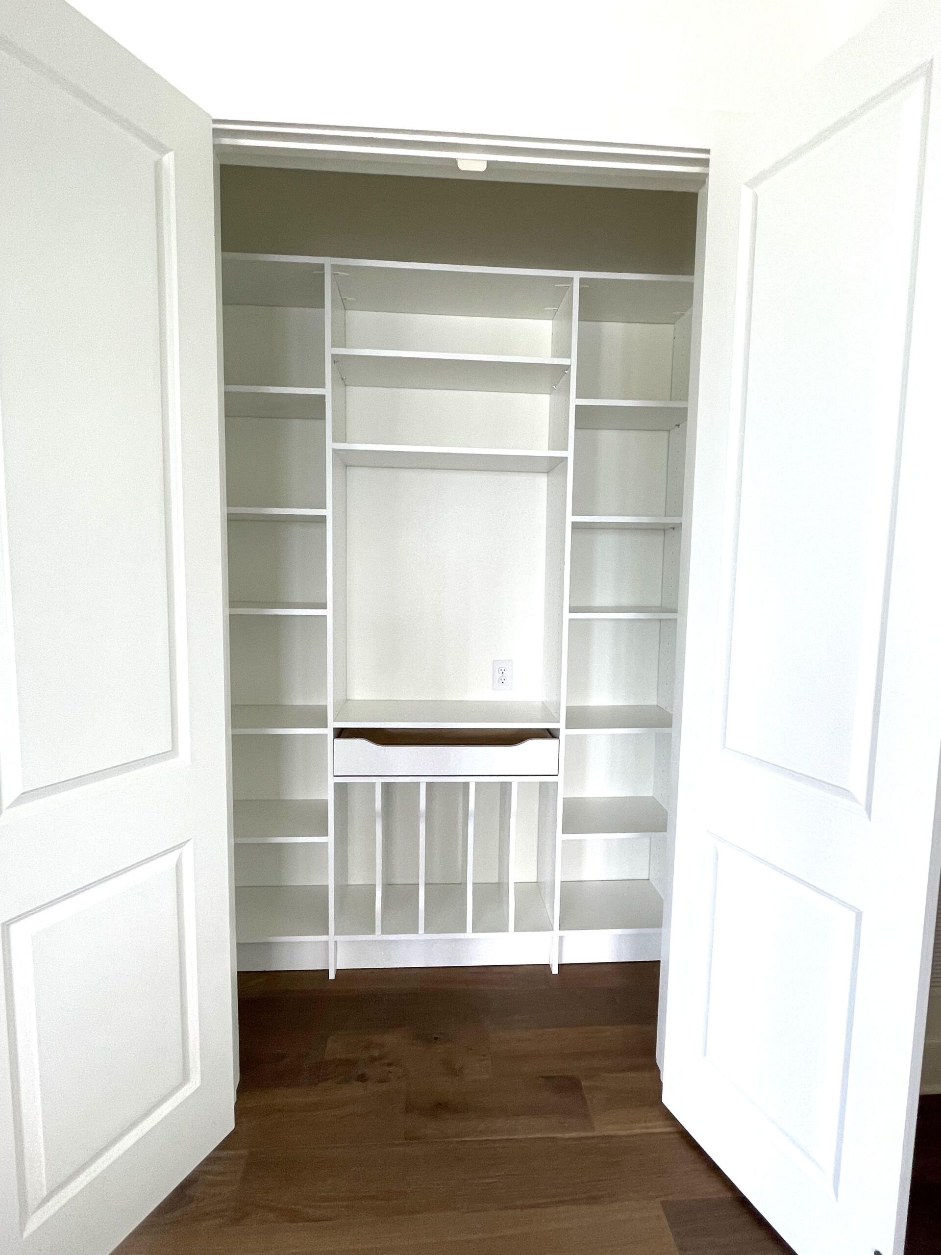 A closet with shelves and a desk in it