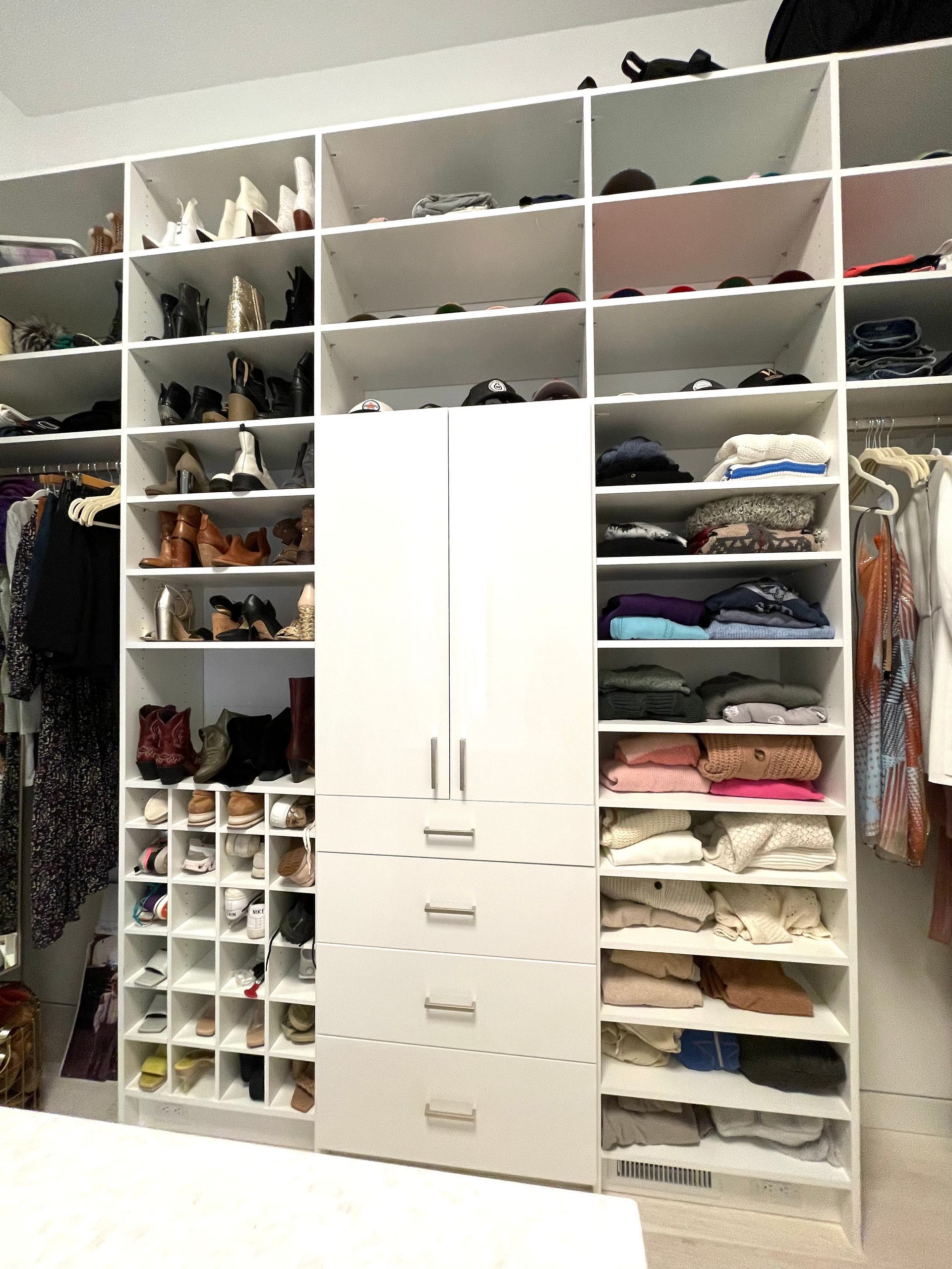 A closet filled with lots of clothes and shoes