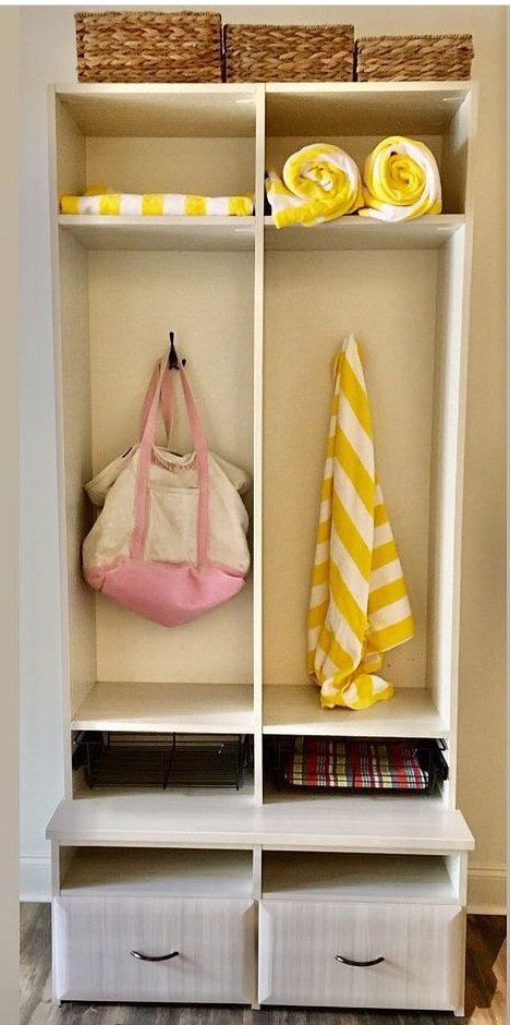 A pink bag is hanging from a hook in a closet.
