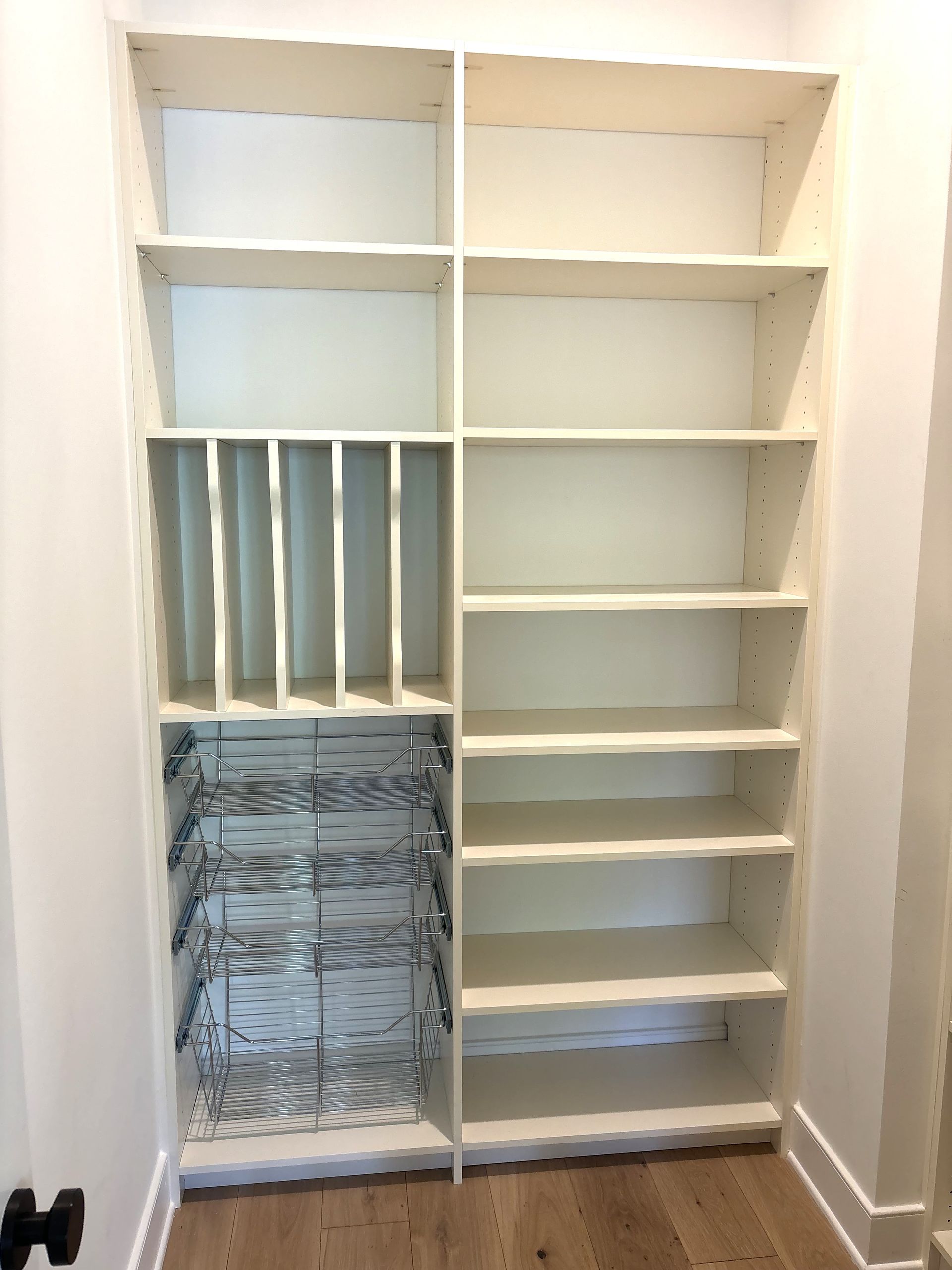 A closet with lots of shelves and a wine rack.