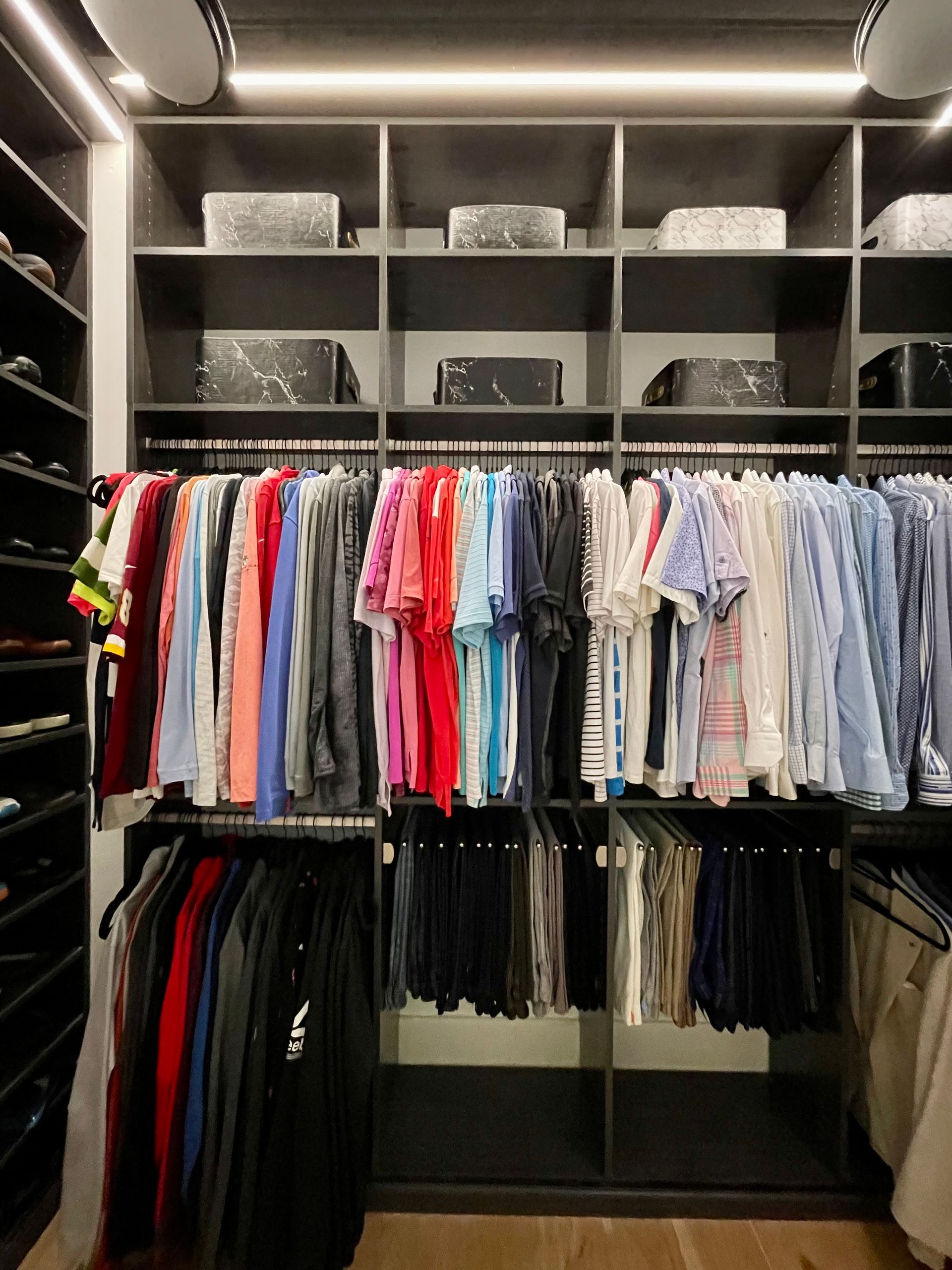 A closet filled with lots of clothes and shoes