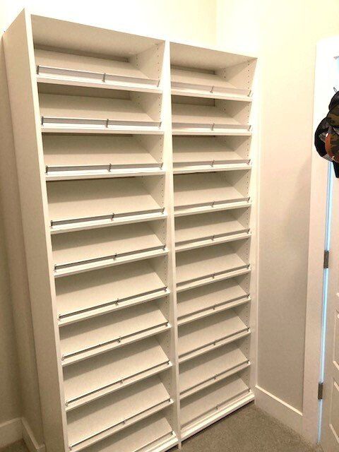 A closet with lots of shelves and a door