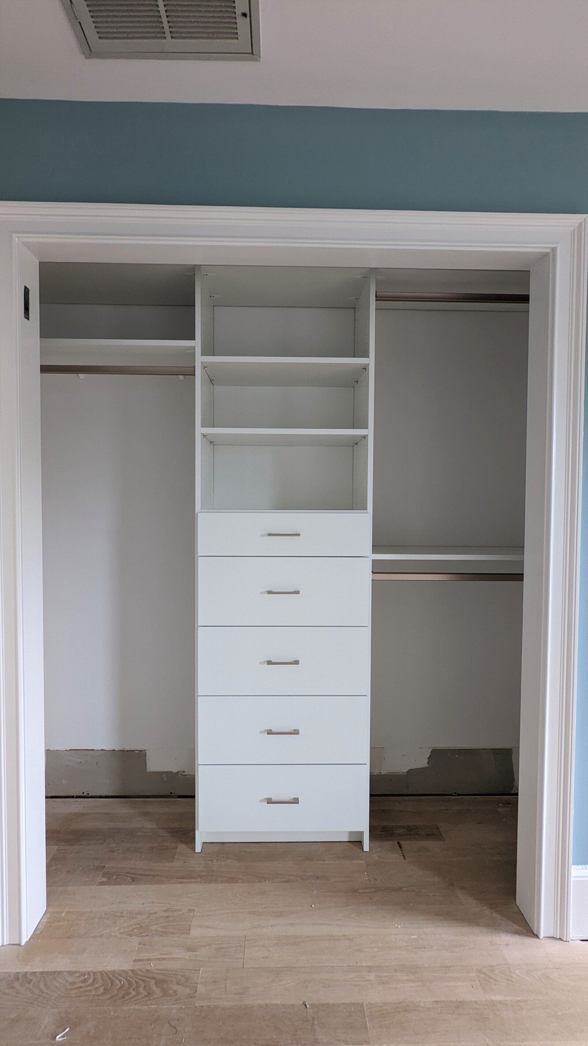 A closet with lots of shelves and drawers in a room.