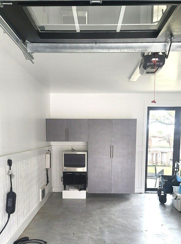 A garage with cabinets and a tv on the wall