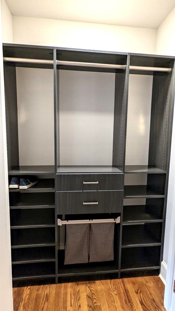 A walk in closet with lots of shelves and drawers.