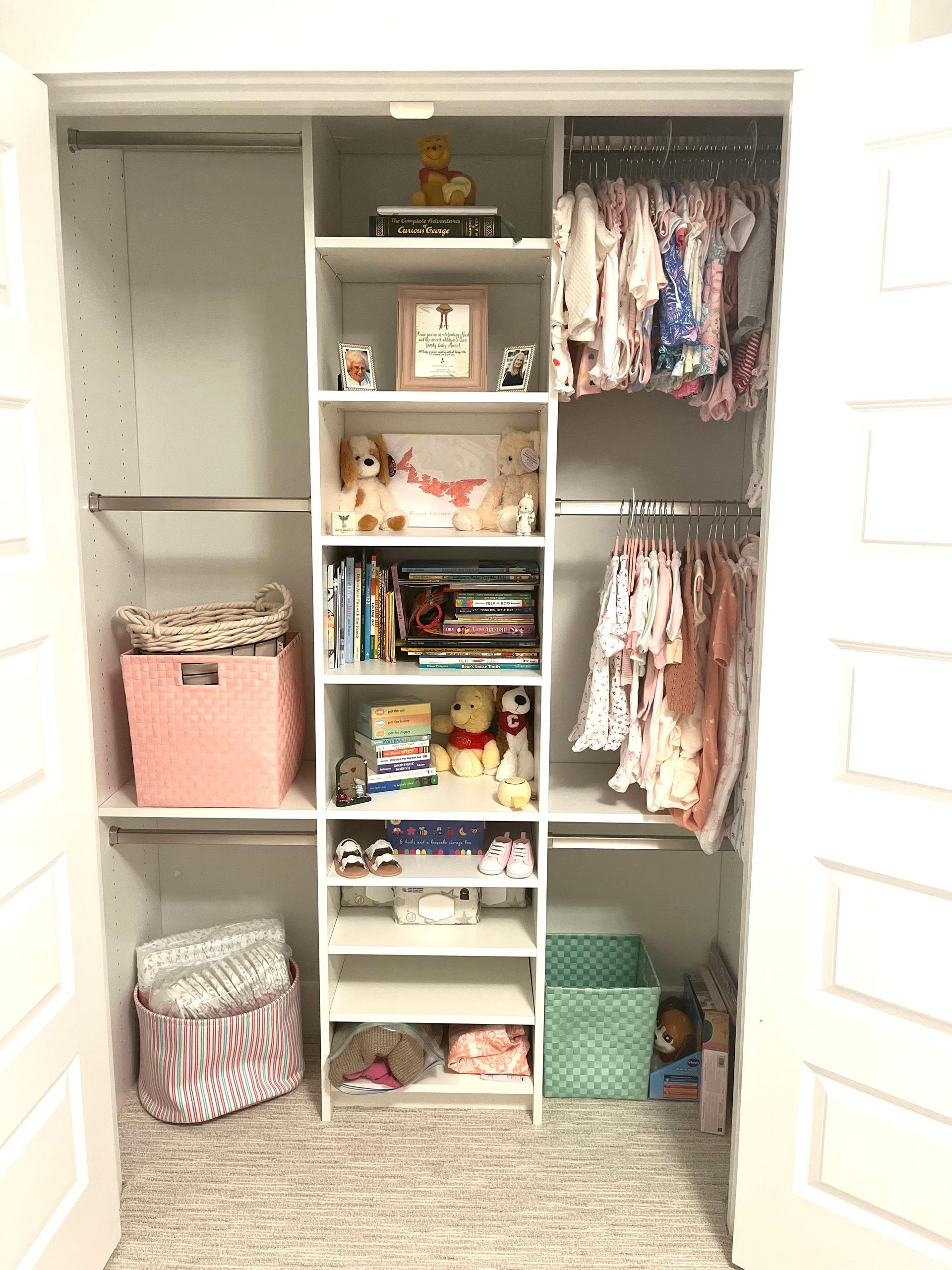 A closet filled with clothes , books , and toys.