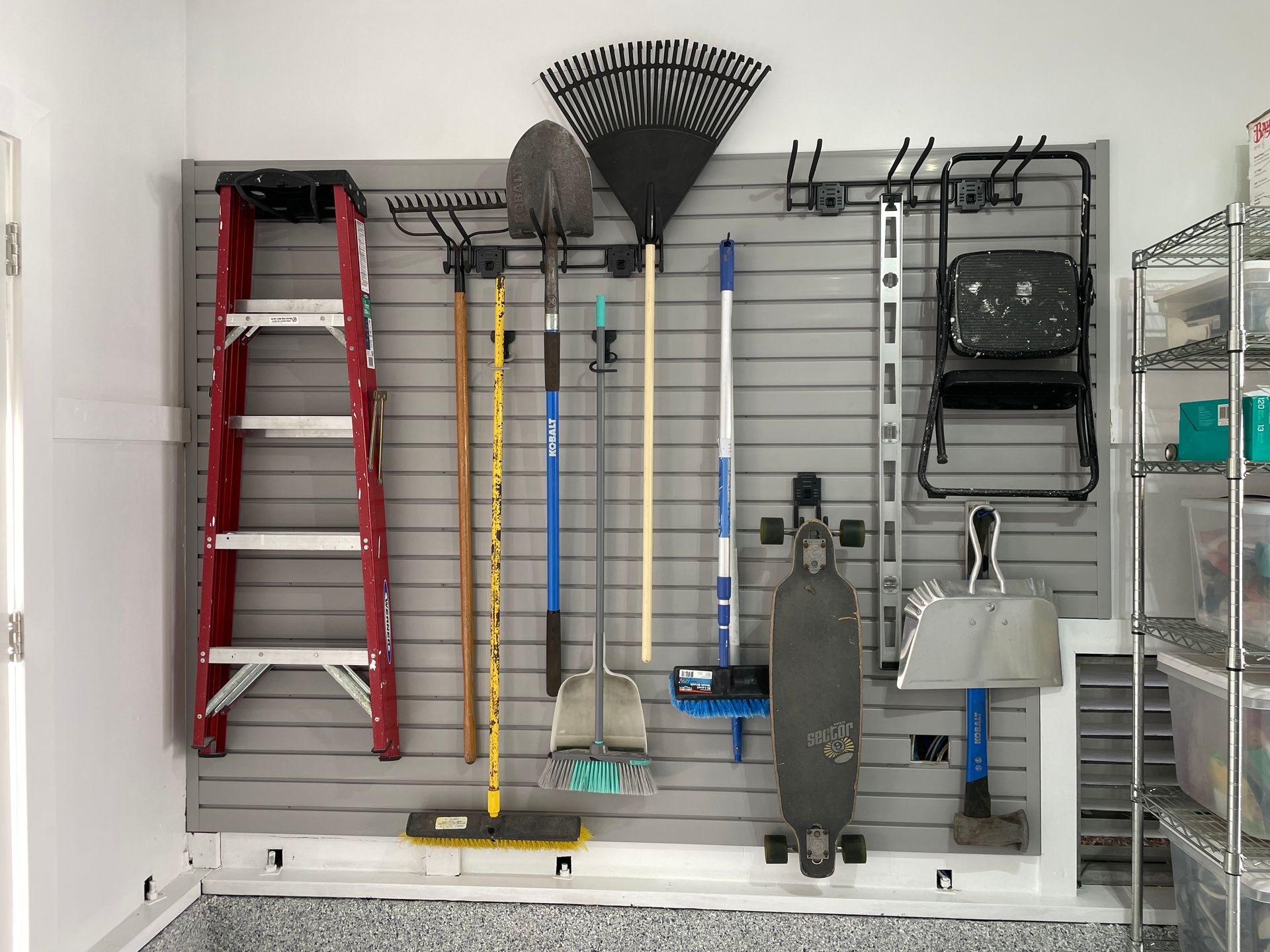 A garage filled with lots of tools and a skateboard.