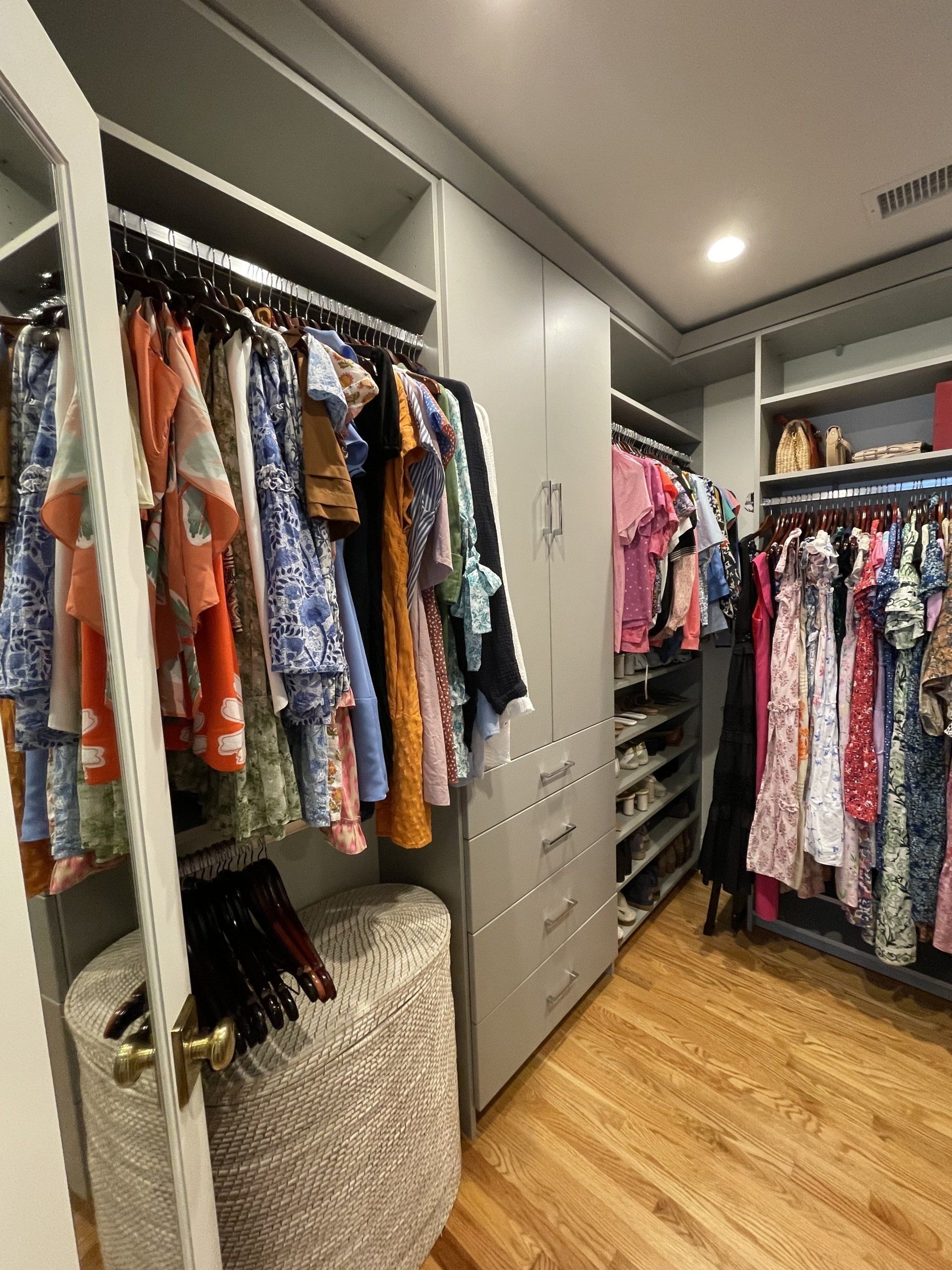 A walk in closet filled with lots of clothes and shoes