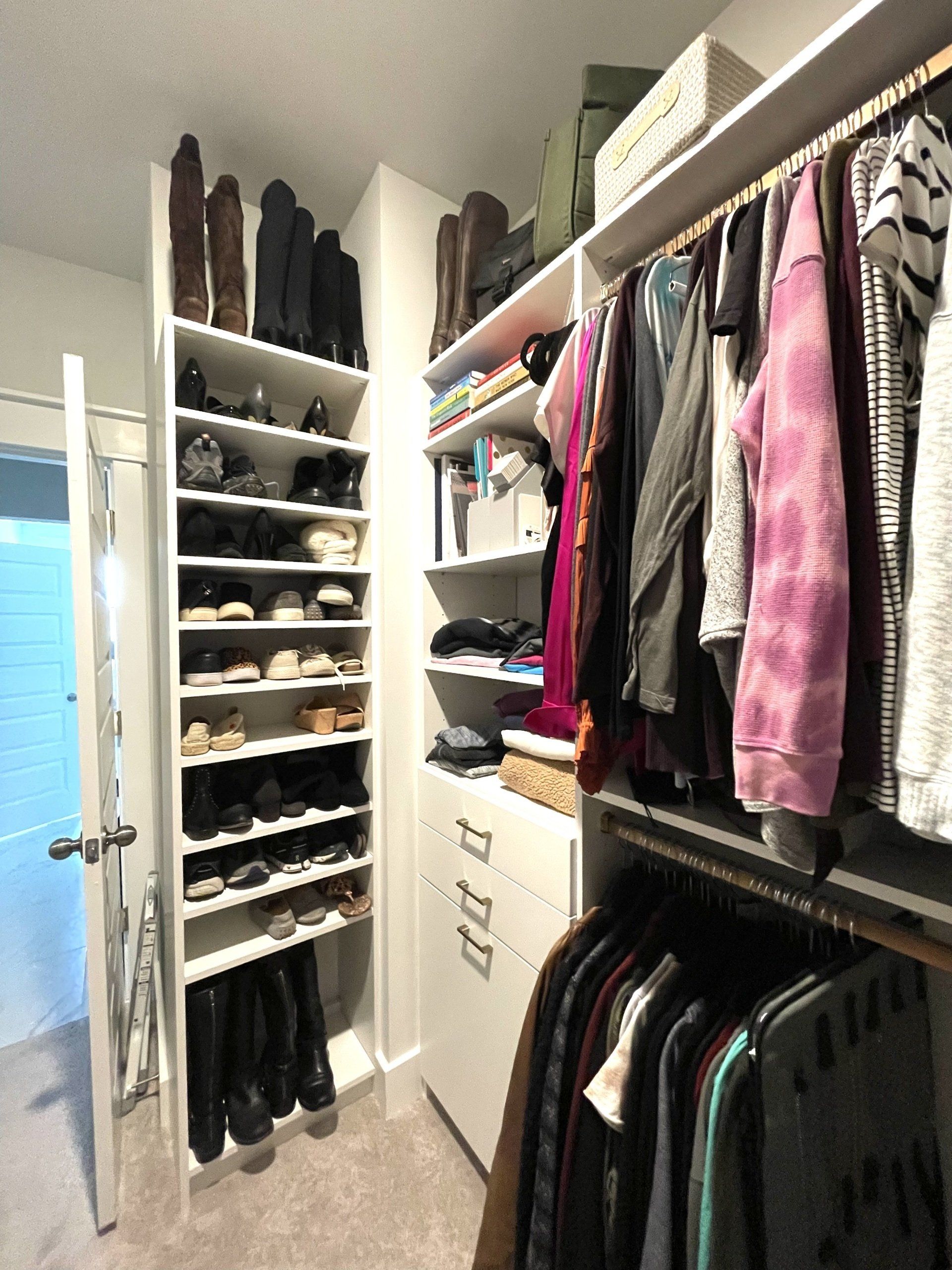 A walk in closet filled with clothes and shoes