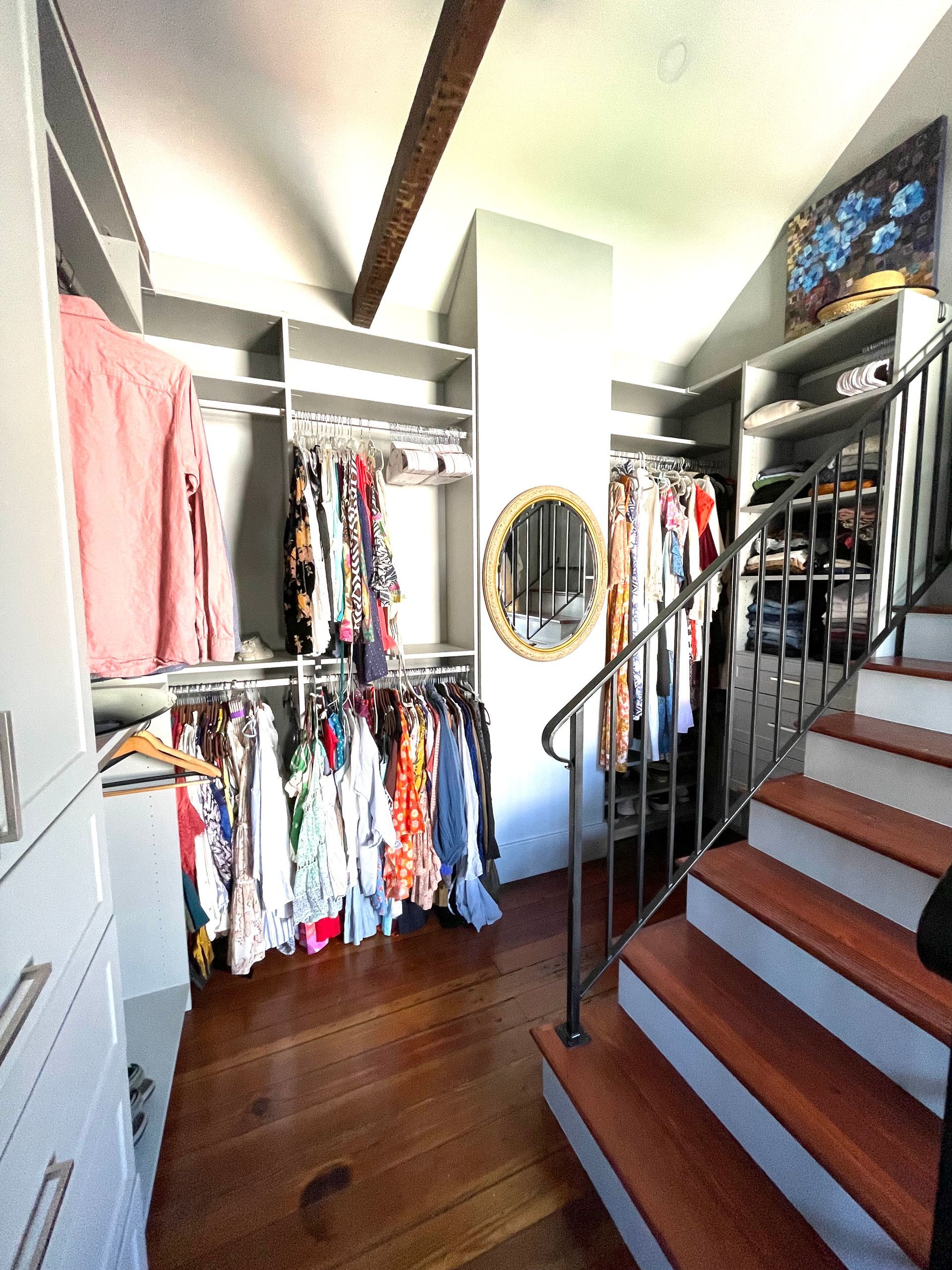 A walk in closet with stairs leading up to it