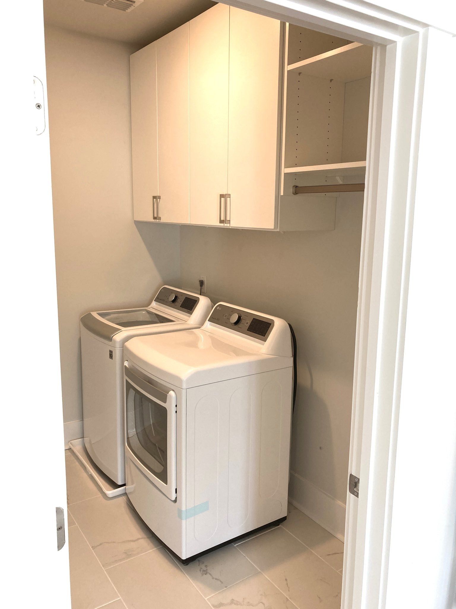 A laundry room with a washer and dryer in it.